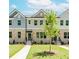 Charming townhome exterior with a well-manicured lawn and inviting entrances at 1240 Ainsworth Aly # 39, Sugar Hill, GA 30518