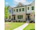 Beautiful townhome exterior with manicured lawn and charming entrance at 1240 Ainsworth Aly # 39, Sugar Hill, GA 30518