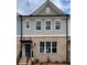 Charming two-story townhome featuring a brick facade, gray siding and a welcoming front door at 1240 Ainsworth Aly # 39, Sugar Hill, GA 30518