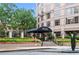 Elegant building entrance featuring 'The Oaks Buckhead' signage, complemented by colorful landscaping and wrought iron details at 3475 Oak Valley Rd # 1850, Atlanta, GA 30326