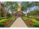 Inviting walkway leads to a building entrance, framed by vibrant flower beds and manicured landscaping at 3475 Oak Valley Rd # 1850, Atlanta, GA 30326