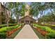 Inviting clubhouse exterior surrounded by colorful flowerbeds and mature trees at 3475 Oak Valley Rd # 1850, Atlanta, GA 30326