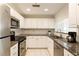 Well-maintained kitchen with stainless appliances, white cabinets, and granite countertops at 3475 Oak Valley Rd # 1850, Atlanta, GA 30326