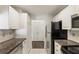 Galley kitchen with white cabinetry, granite countertops, and stainless steel appliances at 3475 Oak Valley Rd # 1850, Atlanta, GA 30326