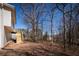 A spacious backyard featuring a newly constructed staircase, surrounded by mature trees and a natural landscape at 2192 Stenger Rd, Douglasville, GA 30135