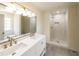 Modern bathroom with dual sinks, quartz countertops, large mirror, and glass-enclosed shower at 2192 Stenger Rd, Douglasville, GA 30135