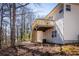 Exterior view of wooden deck overlooking the home's natural landscape and trees at 2192 Stenger Rd, Douglasville, GA 30135