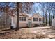 Charming one-story home with light siding, black shutters, and a front yard surrounded by mature trees at 2192 Stenger Rd, Douglasville, GA 30135