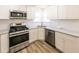 Updated kitchen showcases white cabinets, stainless steel appliances and modern countertops at 2192 Stenger Rd, Douglasville, GA 30135