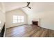 Bright living room featuring vaulted ceiling, fireplace, and large windows at 2192 Stenger Rd, Douglasville, GA 30135