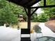 Covered patio with backyard view, including play set and mature trees at 3442 Old Towne Ln, Cumming, GA 30040