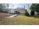 Lush backyard featuring a covered patio, a winding path, and a well-maintained lawn, ideal for relaxation at 3442 Old Towne Ln, Cumming, GA 30040