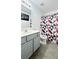 Bathroom with geometric shower curtain, stylish mirror, and tile flooring at 3442 Old Towne Ln, Cumming, GA 30040
