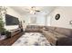 Comfortable living room with a large sectional sofa, wood floors, and a decorative rug at 3442 Old Towne Ln, Cumming, GA 30040