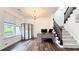 Well-lit office space with hardwood floors, a modern desk, and staircase access at 3442 Old Towne Ln, Cumming, GA 30040