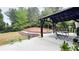 Lovely patio with a dark pergola, concrete flooring, landscaping and outdoor seating, creating a relaxing outdoor space at 3442 Old Towne Ln, Cumming, GA 30040