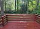 View of wooded backyard from a wooden deck with red railing at 4015 Woodland Nw Dr, Kennesaw, GA 30152