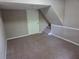 Basement area with a carpeted floor, white door, and stairs at 4015 Woodland Nw Dr, Kennesaw, GA 30152