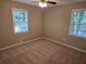 Comfortable bedroom with neutral carpet and two windows allowing natural light at 4015 Woodland Nw Dr, Kennesaw, GA 30152