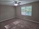 Cozy bedroom with neutral carpet, a ceiling fan, and a bright window view at 4015 Woodland Nw Dr, Kennesaw, GA 30152