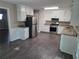 Well-lit kitchen featuring white cabinets, granite countertops, and stainless steel appliances at 4015 Woodland Nw Dr, Kennesaw, GA 30152