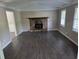 Spacious living room with a stone fireplace, large windows, and modern flooring at 4015 Woodland Nw Dr, Kennesaw, GA 30152