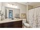 Bathroom with granite vanity top, decorative mirror, and floral shower curtain at 4192 Alaina Cir, Austell, GA 30106