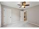 Neutral bedroom with a ceiling fan, showing access to a closet and adjoining room at 4192 Alaina Cir, Austell, GA 30106
