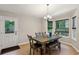 Cozy dining area featuring a modern table set, natural light, and a view of the outdoor greenery at 4192 Alaina Cir, Austell, GA 30106