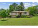 Charming single-Gathering home with a well-manicured lawn, mature trees, and tasteful landscaping at 4192 Alaina Cir, Austell, GA 30106