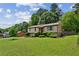 Well-maintained home with verdant lawn and mature trees, offering a serene and inviting atmosphere at 4192 Alaina Cir, Austell, GA 30106