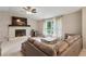 Comfortable living room with a corner fireplace, plush seating, and large windows showcasing the outdoor view at 4192 Alaina Cir, Austell, GA 30106