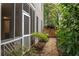 Charming backyard featuring a gravel path leading to a wooden gate, surrounded by lush greenery at 626 Kimberly Ne Ln, Atlanta, GA 30306