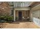 Inviting front porch with seating area, charming architectural details, and a well-manicured garden at 626 Kimberly Ne Ln, Atlanta, GA 30306