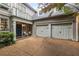 View of the front exterior with a two-car garage, a charming entryway with chairs, and manicured landscaping at 626 Kimberly Ne Ln, Atlanta, GA 30306