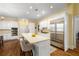 Bright kitchen with island featuring bar stool seating, built-in oven and stainless steel refrigerator at 626 Kimberly Ne Ln, Atlanta, GA 30306