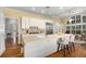 Bright kitchen with island, bar seating, stainless steel refrigerator, and view to breakfast area at 626 Kimberly Ne Ln, Atlanta, GA 30306