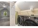 Well-lit laundry room with side-by-side washer and dryer, and ample space for storage at 626 Kimberly Ne Ln, Atlanta, GA 30306