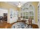 Elegant library featuring hardwood floors, custom built-ins, and a large arched window overlooking the yard at 626 Kimberly Ne Ln, Atlanta, GA 30306