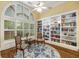 Bright library with hardwood floors, built-in bookshelves, and ample natural light from large windows at 626 Kimberly Ne Ln, Atlanta, GA 30306