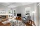 Cozy living room with fireplace, built-ins, hardwood floors, and ample natural light from large windows at 626 Kimberly Ne Ln, Atlanta, GA 30306