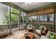 Relaxing screened porch featuring stone flooring, cozy seating, and a view of lush greenery at 626 Kimberly Ne Ln, Atlanta, GA 30306