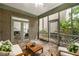 Inviting screened-in porch with wood furniture, stone floors, and views of the private backyard at 626 Kimberly Ne Ln, Atlanta, GA 30306