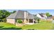 Spacious backyard with covered patio, firepit, and established landscaping at 1625 Alcovy River Dr, Dacula, GA 30019