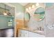 Bathroom with dual vanity, granite counters, decorative tile backsplash and designer lighting at 1625 Alcovy River Dr, Dacula, GA 30019