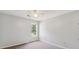 Bedroom with plush carpet, a ceiling fan, and a window providing natural light at 1625 Alcovy River Dr, Dacula, GA 30019