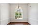 Dining room featuring a large window with backyard views and a modern chandelier light fixture at 1625 Alcovy River Dr, Dacula, GA 30019