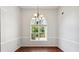 Dining room with hardwood floors, wainscoting, and a decorative chandelier at 1625 Alcovy River Dr, Dacula, GA 30019