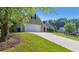 Long driveway leading to an attached garage on a well-maintained lot at 1625 Alcovy River Dr, Dacula, GA 30019