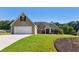 Well-maintained home with a spacious lawn and an attached two-car garage at 1625 Alcovy River Dr, Dacula, GA 30019